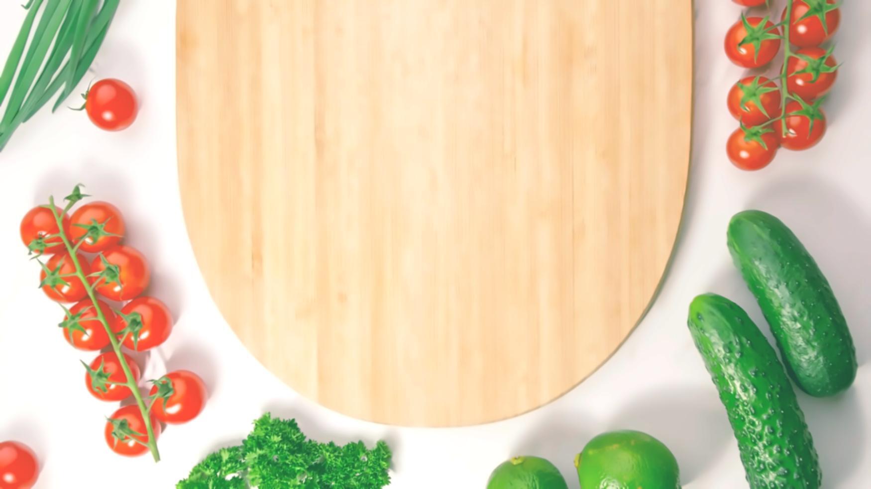 Close-up of hands carefully slicing vegetables on a chopping board
